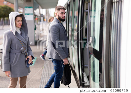 People boarding streetcar 65099729