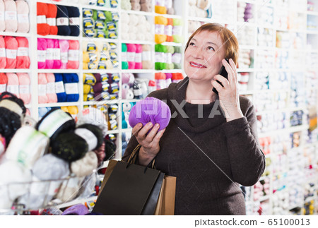 Senior female using smartphone after shopping Senior female using smartphone after shopping 65100013