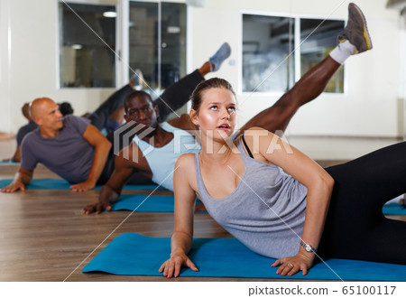 People doing stretching exercises 65100117