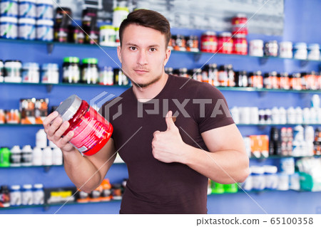 muscular man giving thumbs up muscular man giving thumbs up 65100358