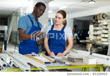 Two masters are working on their workplace 65100403