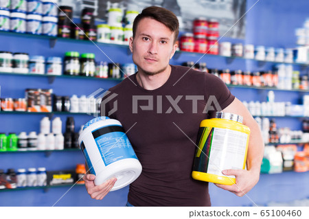 Portrait of young guy with sport nutrition Portrait of young guy with sport nutrition 65100460