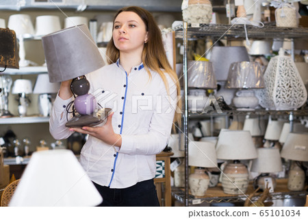 woman is looking on table lamps woman is looking on table lamps 65101034