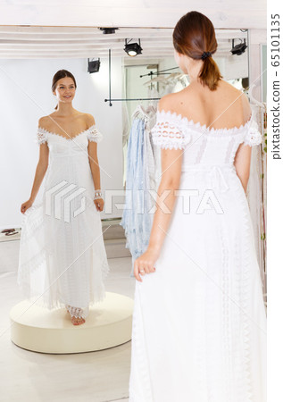 Woman flaunting dressed in wedding gown 65101135