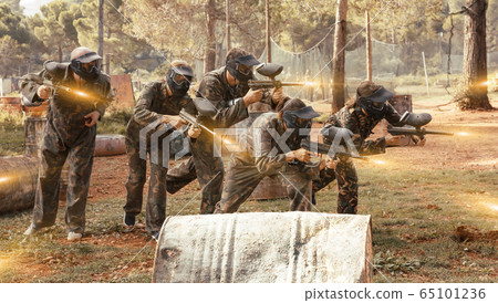 Group of people playing paintball Group of people playing paintball 65101236