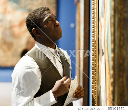 African man looking at exhibit 65101351
