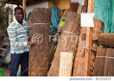Gardener looking for decorative fence at market 65101637