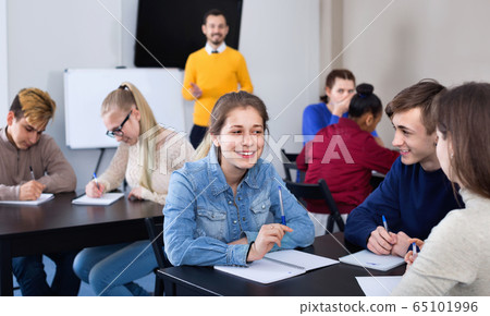 Fellow students having group work tasks during school day Fellow students having group work tasks during school day 65101996