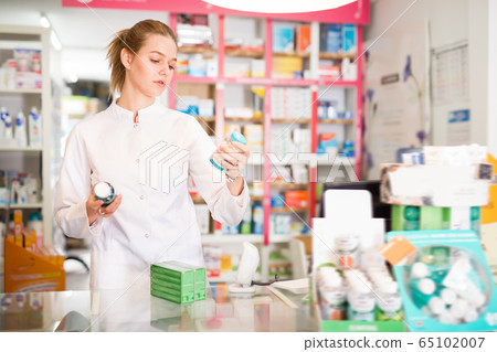 Diligent smiling female druggist Diligent smiling female druggist 65102007