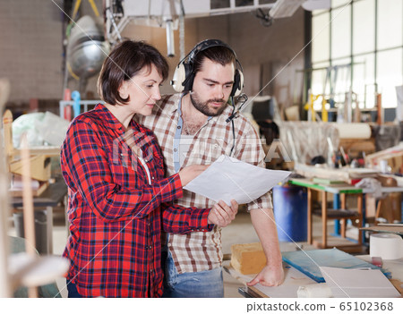 Team of aircraft enthusiasts checking drawings Team of aircraft enthusiasts checking drawings 65102368