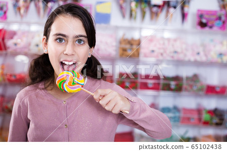 Emotional schoolgirl with lollipop Emotional schoolgirl with lollipop 65102438