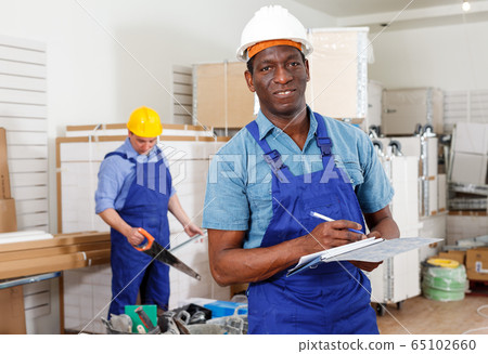 African-American contractor determining scope of building work African-American contractor determining scope of building work 65102660