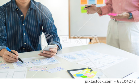 Graphic designers team work together with UX UI Graphic designers team work together with UX UI 65104278