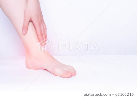 Girl smears medical ointment ankle on a white background, treatment of synovitis and bursitis, inflammation, copy space, osteoarthritis Girl smears medical ointment ankle on a white background, treatment of synovitis and bursitis, inflammation, copy space, osteoarthritis 65105216