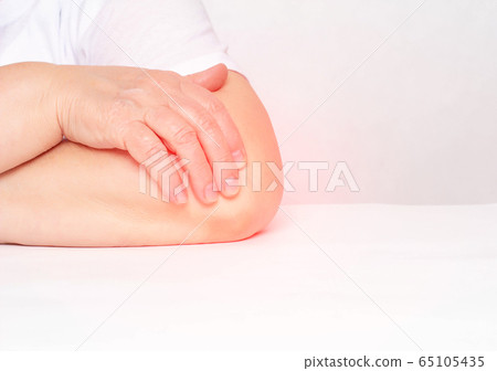 Pain in the elbow joint in a woman, tendonitis and bursitis, degenerative lesions in the joint, white background, copy space, osteoarthritis 65105435