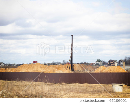 Construction and construction of the foundation on reinforced concrete driving piles in poor soil, machinery and equipment for piles, hydraulic hammer, copy space Construction and construction of the foundation on reinforced concrete driving piles in poor soil, machinery and equipment for piles, hydraulic hammer, copy space 65106001