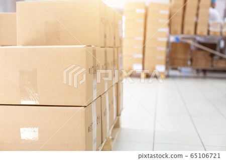 Warehouse with its own production. A pile of cardboard boxes on a pallet. The concept of shipping and delivery of goods from a warehouse, logistics, industry, copy space Warehouse with its own production. A pile of cardboard boxes on a pallet. The concept of shipping and delivery of goods from a warehouse, logistics, industry, copy space 65106721