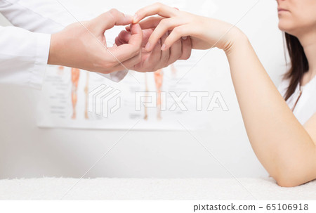 A neurologist doctor checks the pathological reflex of a hoffman in a girl for the presence of neuropathologies. Nervous system, 65106918