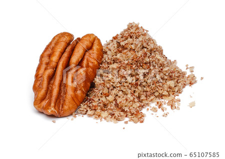 Heap of granulated pecan nut isolated Heap of granulated pecan nut isolated 65107585