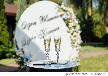 A row of empty champagne glasses on table. Banquet setting A row of empty champagne glasses on table. Banquet setting 65108294