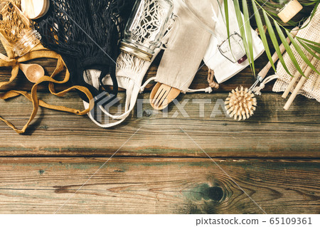 Zero waste concept. Textile eco bags, glass jars, bamboo recycled tableware on wooden background Zero waste concept. Textile eco bags, glass jars, bamboo recycled tableware on wooden background 65109361