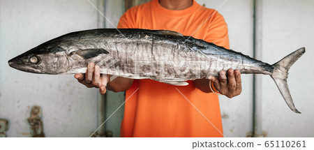 Salted mackerels fish or Pla Insee Kem. Seafood in fisherman hands Salted mackerels fish or Pla Insee Kem. Seafood in fisherman hands 65110261