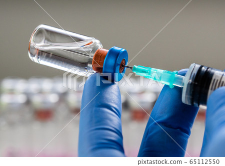 close up on vaccine and medical syringe close up on vaccine and medical syringe 65112550