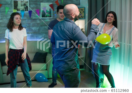 Gathering of young people dancing in an apartment Gathering of young people dancing in an apartment 65112960