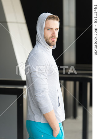 Guy bearded and attractive hooded looks back. Man 65113461
