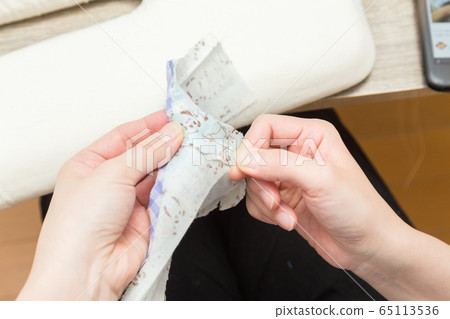 A woman sewing 65113536