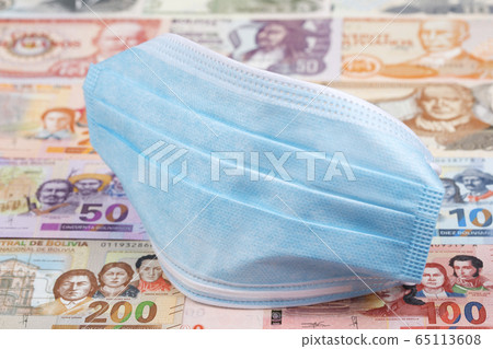Protective mask on a Bolivian money 65113608