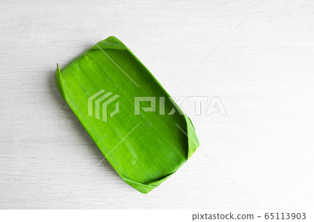 Green leaf of a banana. Eco dishes for food. 65113903