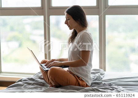 A beautiful young brunette girl is working on the A beautiful young brunette girl is working on the 65113924