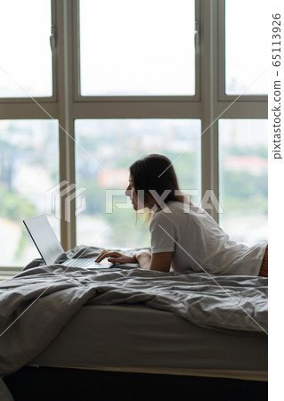 A beautiful young brunette girl is working on the A beautiful young brunette girl is working on the 65113926