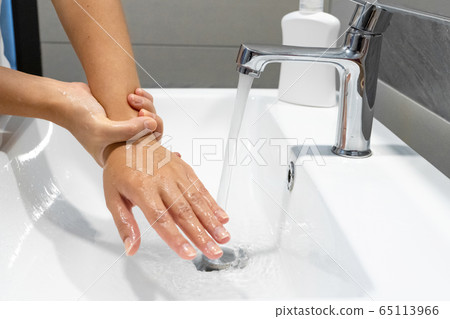 Washing hands rubbing with soap woman for corona 65113966