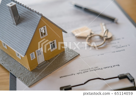 Desk of real estate agent with house model for contract to buy, get insurance or loan estate. Desk of real estate agent with house model for contract to buy, get insurance or loan estate. 65114059