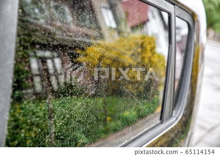 Allergy season. Yellow pollen on window of car 65114154