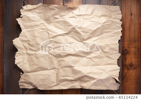wrinkled paper at wooden board background wrinkled paper at wooden board background 65114224