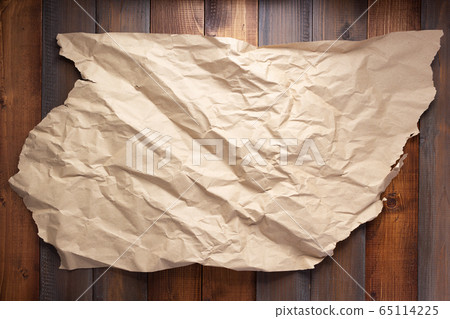 wrinkled paper at wooden board background wrinkled paper at wooden board background 65114225