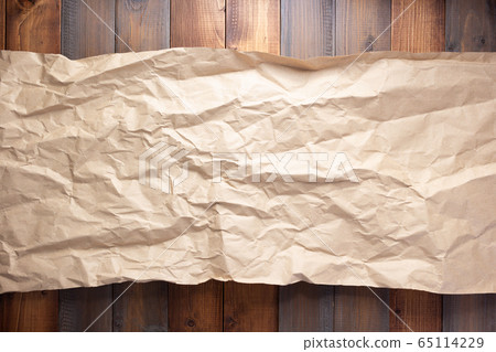 wrinkled paper at wooden board background wrinkled paper at wooden board background 65114229