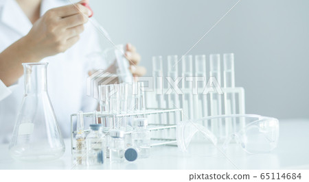 Scientist with a tube of biological sample test  65114684