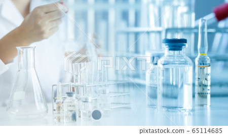 Scientist with a tube of biological sample test  65114685