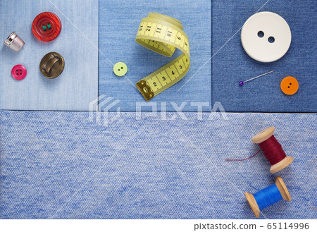 sewing tools and accessories on jeans background 65114996