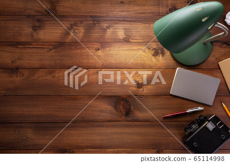 notepad or paper notebook and lamp at wooden table 65114998