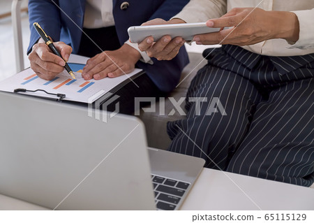 Business team brainstorming and discussing with financial data and report graph. Business team brainstorming and discussing with financial data and report graph. 65115129