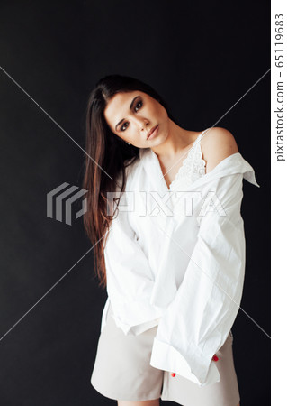 Portrait of a beautiful fashionable oriental brunette woman in a white shirt and shorts Portrait of a beautiful fashionable oriental brunette woman in a white shirt and shorts 65119683