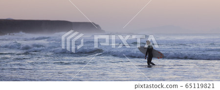 Surfers on beach with surfboard. Surfers on beach with surfboard. 65119821