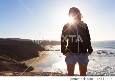 Free happy woman winter vacation on La Pared beach, Fuerteventura, Canary Islands, Spain. Free happy woman winter vacation on La Pared beach, Fuerteventura, Canary Islands, Spain. 65119822
