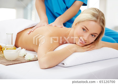Young beautiful woman in spa environment 65120700