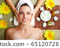 Young beautiful woman in spa environment 65120728